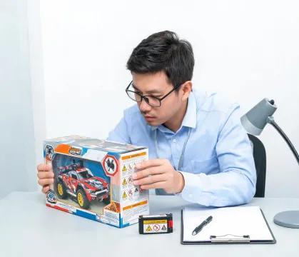 Toy safety reviewer checking RC packaging labels